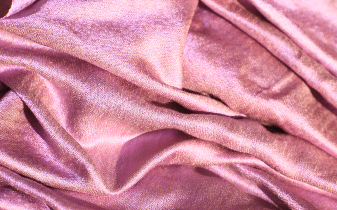 Slightly crumpled pink polyester fabric